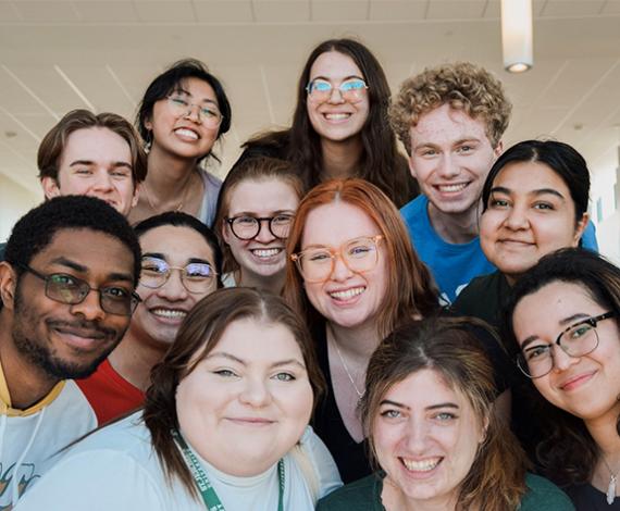 students volenteers smiling excitedly and posing together for a photograph in preparation St. Jerom'es Feast Celebration